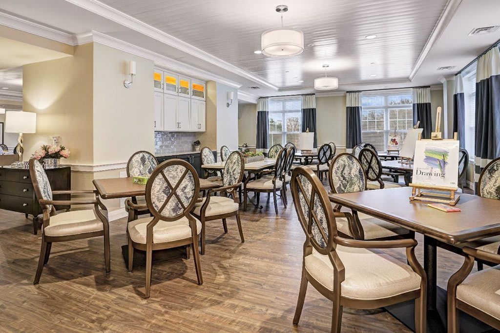A well-lit dining room with elegant furniture and ample natural light.