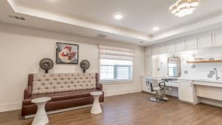A modern hair salon interior with seating and styling stations.