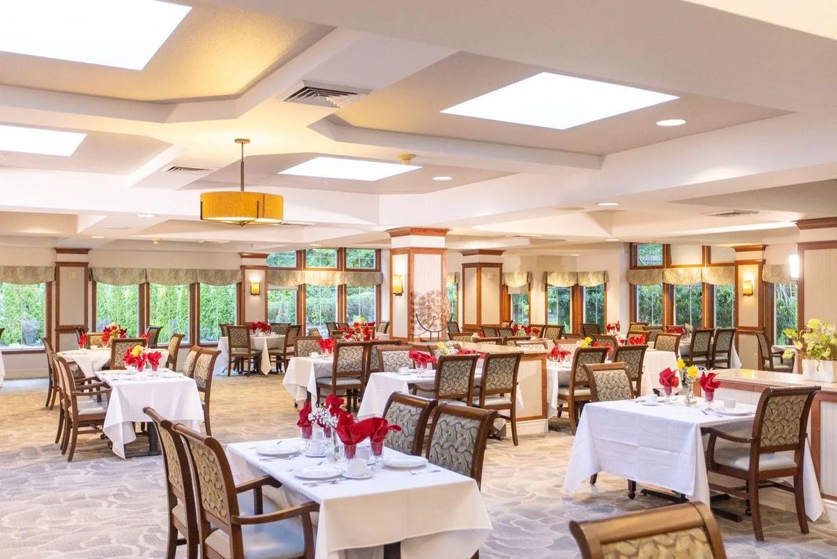 Elegant dining room with neatly arranged tables and warm lighting.