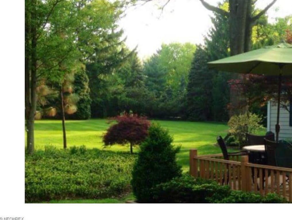 A picturesque garden with lush greenery and a well-maintained lawn.