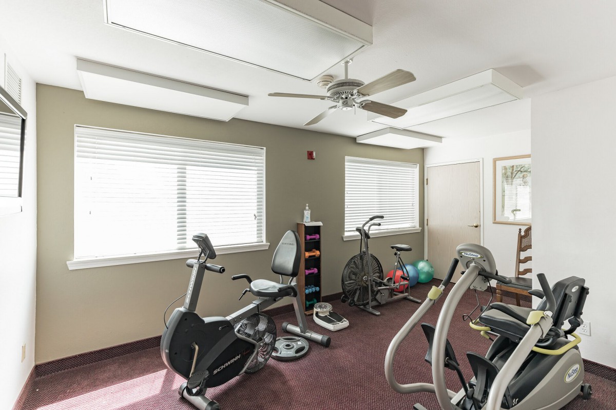 A small gym room with exercise bikes and fitness equipment.