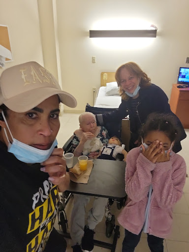 A heartfelt moment shared in the hospital, capturing family and caregivers supporting a loved one.