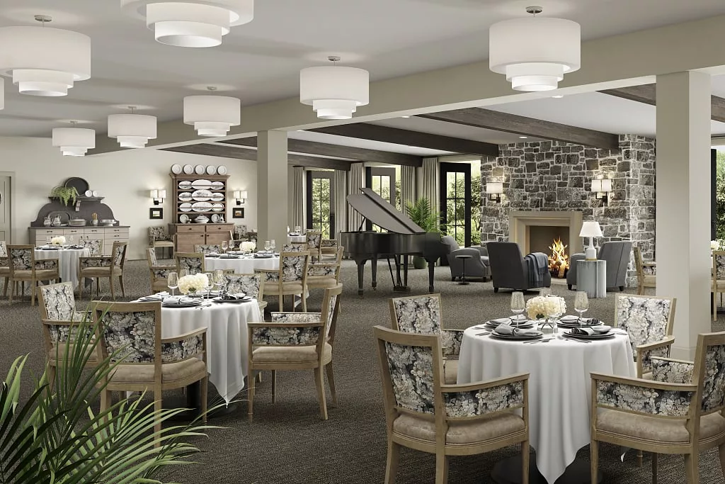 An elegant dining room interior with neatly arranged tables and a cozy fireplace.