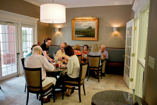 A lively gathering of friends enjoying a meal together in a cozy dining setting.