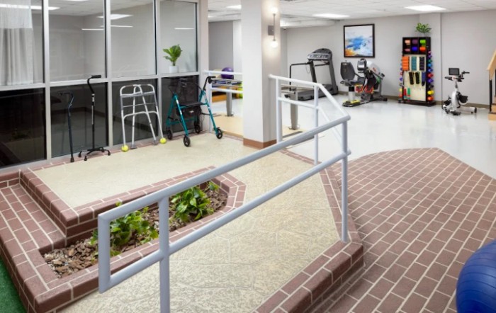 A healthcare facility featuring a wheelchair ramp and various rehabilitation equipment.