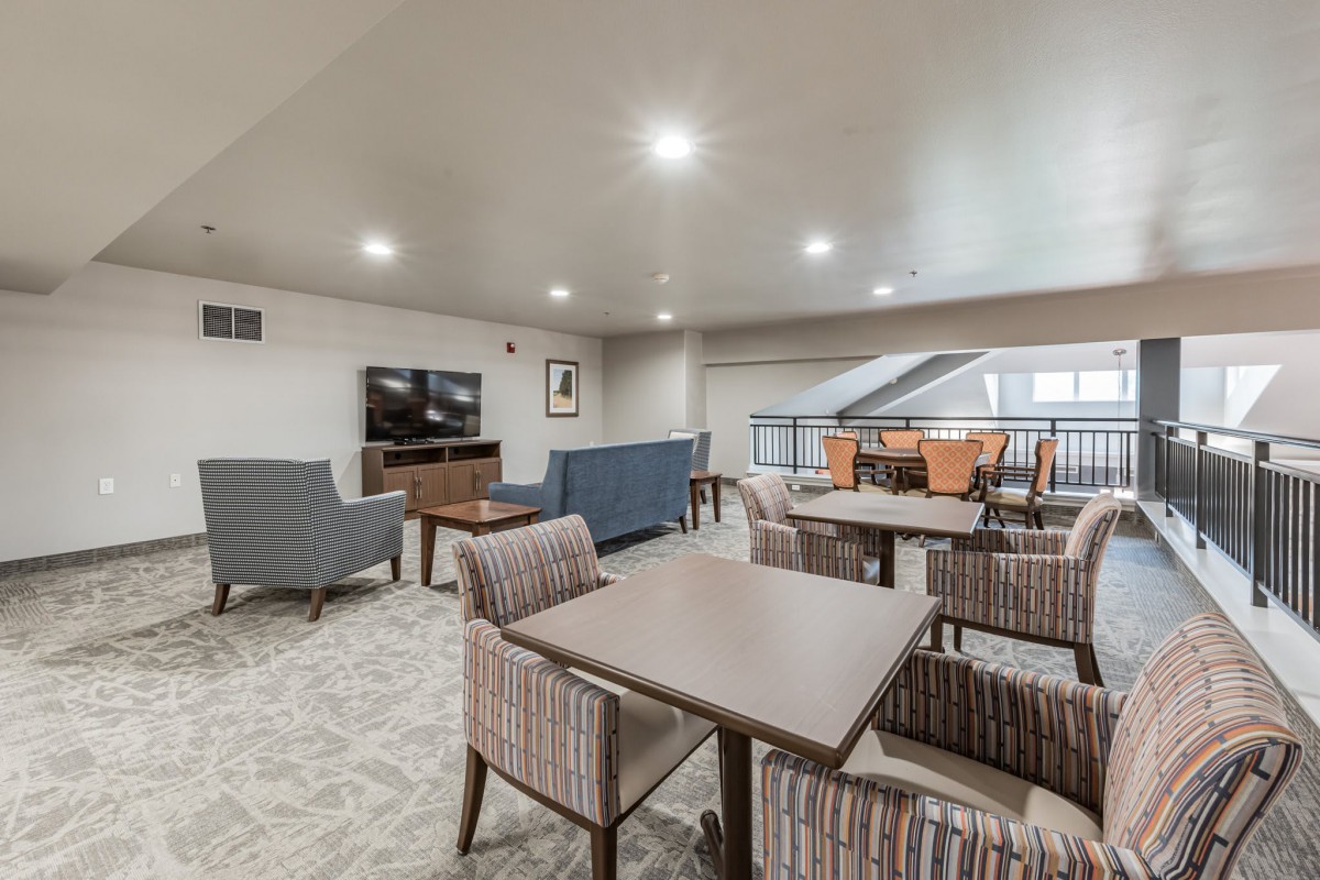 A modern lounge area with comfortable seating and a television.