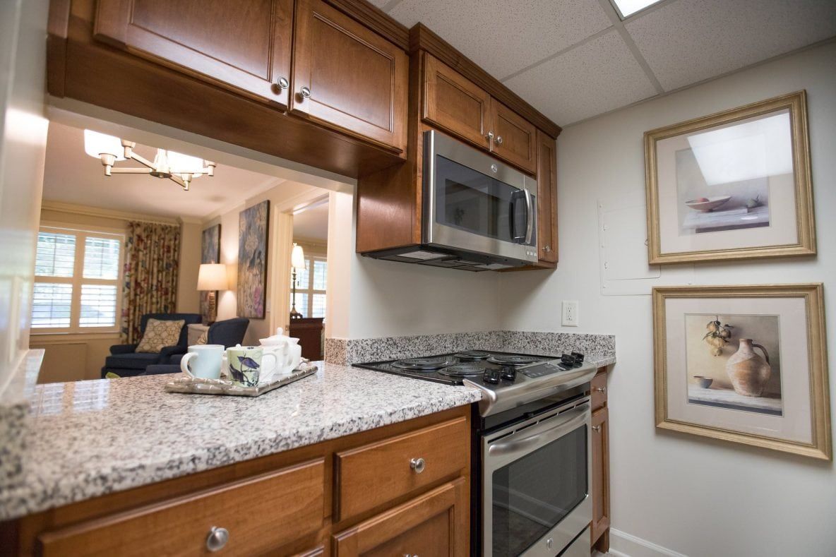 A modern kitchen with wood cabinets and stainless steel appliances.