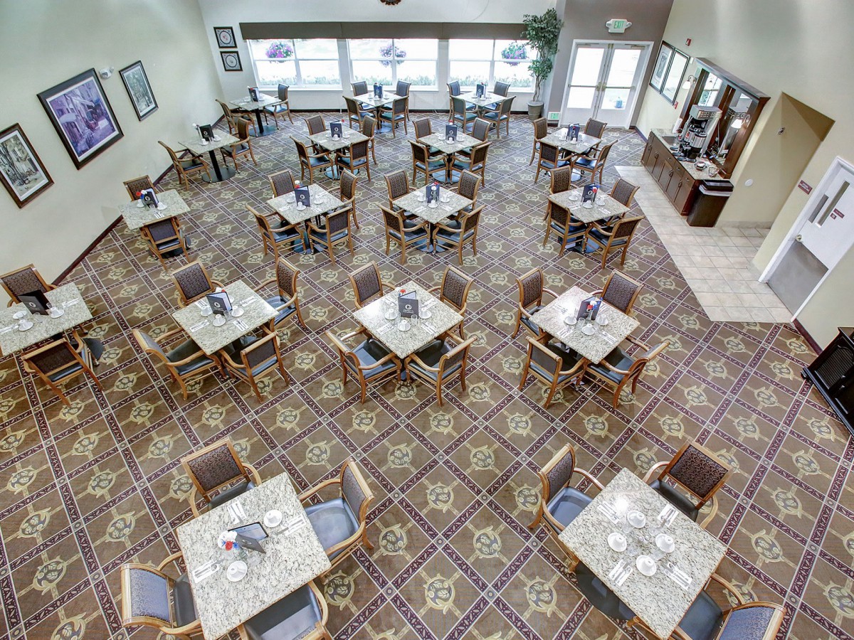 An overhead view of a dining room with neatly arranged tables and chairs.