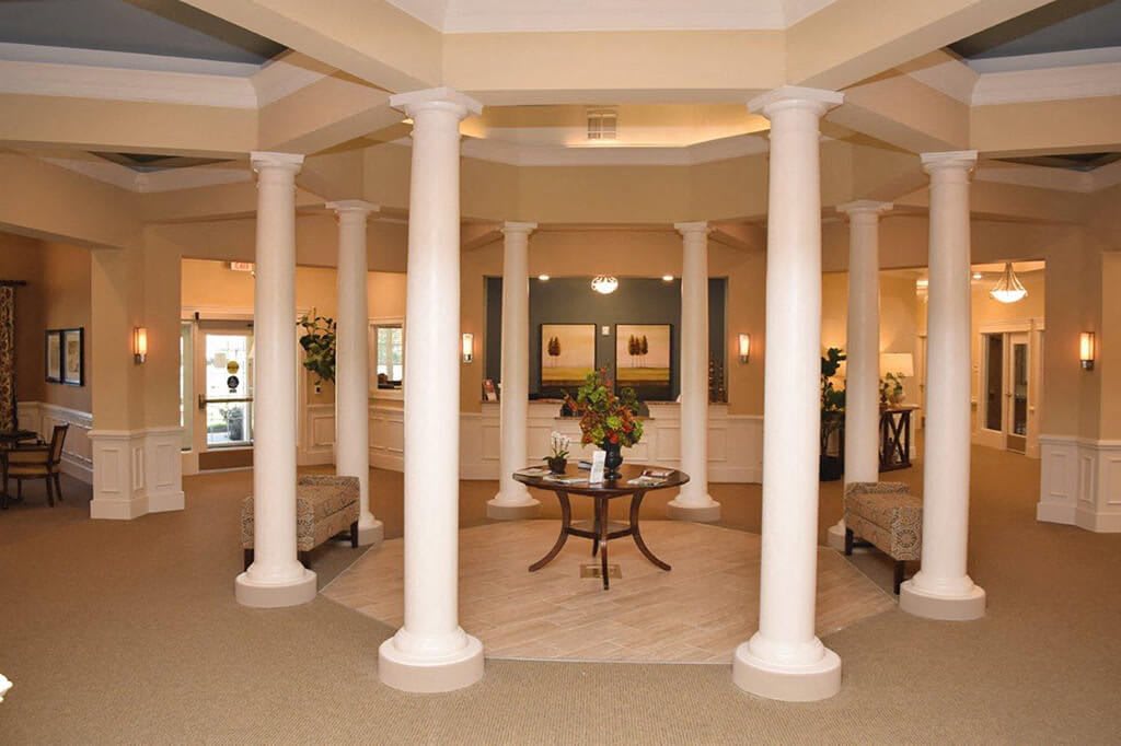 A spacious lobby featuring elegant columns and comfortable seating.