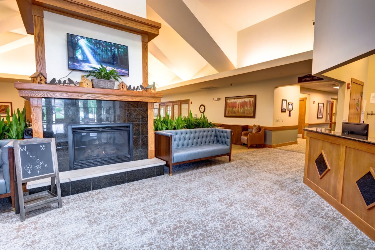 A modern and spacious lobby with a fireplace and contemporary seating.