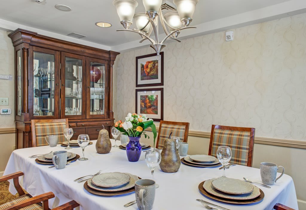 A well-appointed dining room with an elegant table setting and decorative accents.
