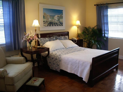A cozy and inviting bedroom featuring a comfortable bed, elegant furnishings, and warm lighting.