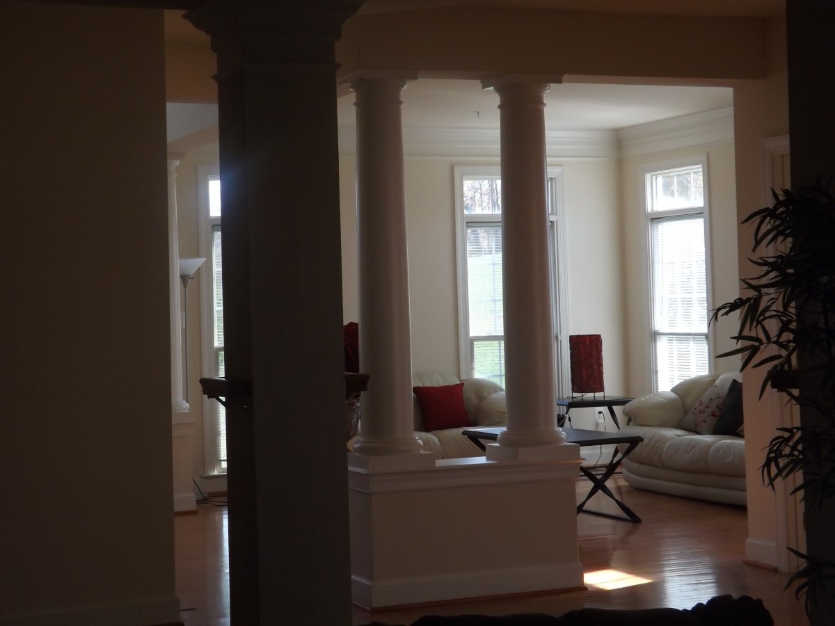 A cozy living room with elegant columns and ample natural light.