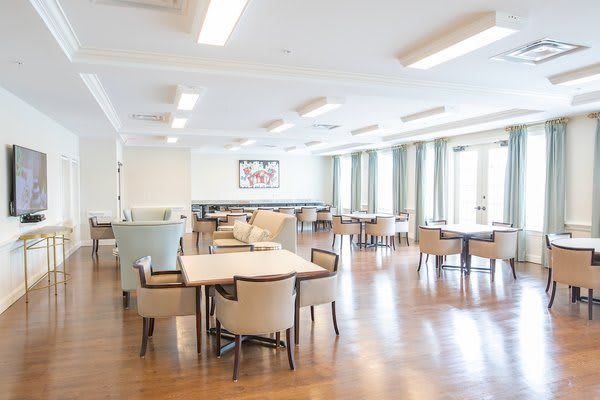 A spacious and modern dining area with wooden floors and contemporary furniture.