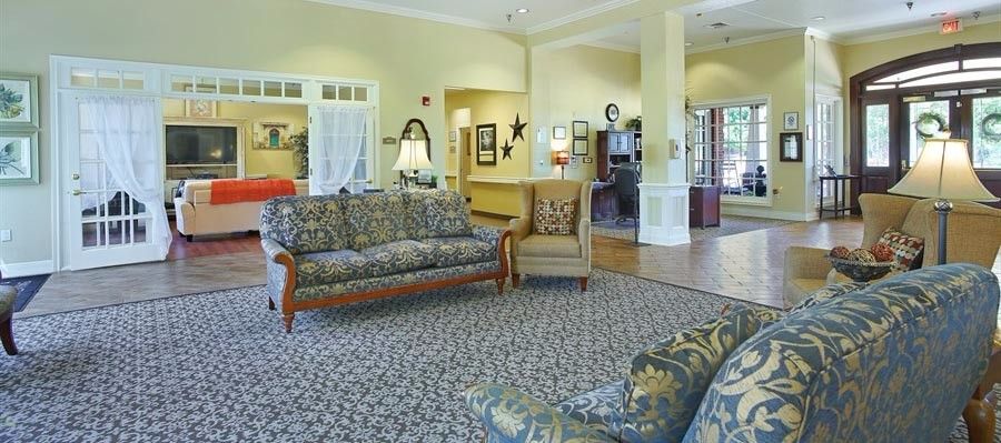 A cozy living room with elegant furniture and a patterned carpet.