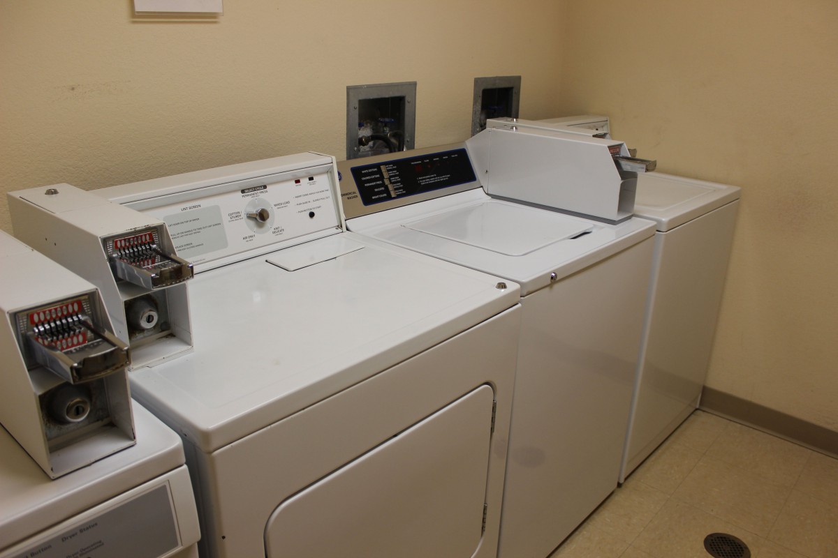 A laundry room featuring a washing machine and dryer side by side.