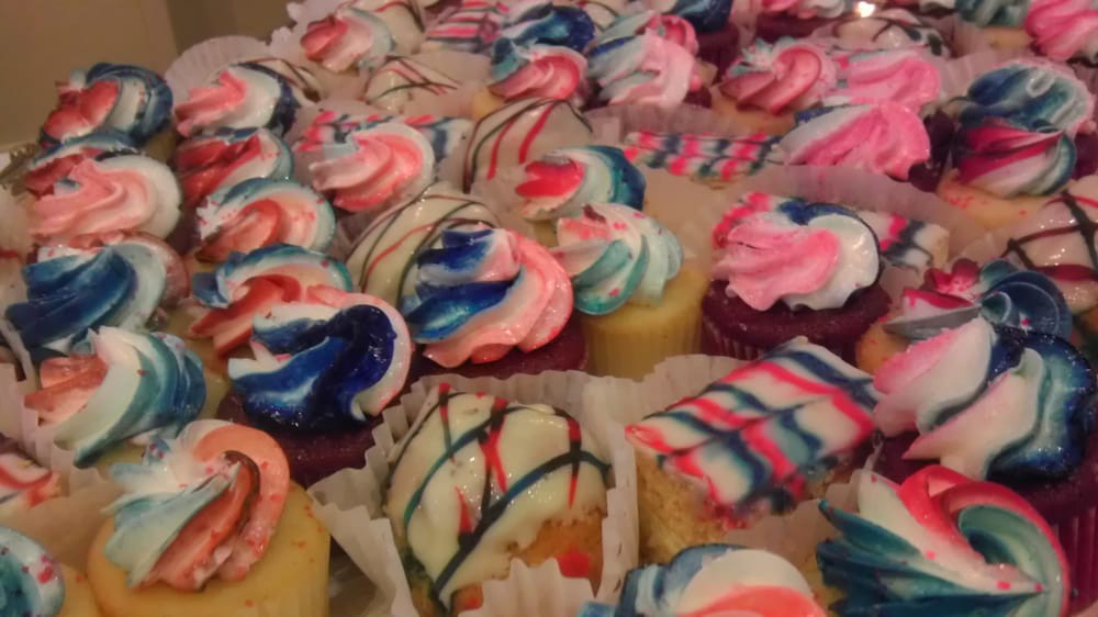 A delightful assortment of colorful frosted cupcakes.