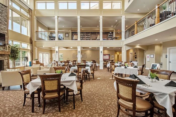 A spacious and elegant dining area with neatly arranged tables and chairs.