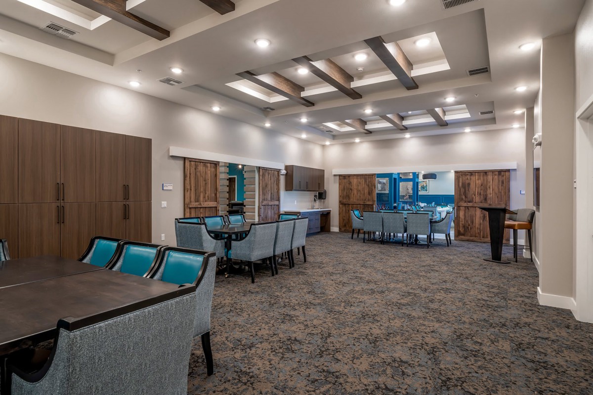 A spacious and modern conference room with stylish furniture and lighting.