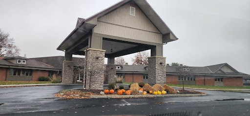 A welcoming entrance adorned with pumpkins and hay bales, showcasing the beauty of autumn.