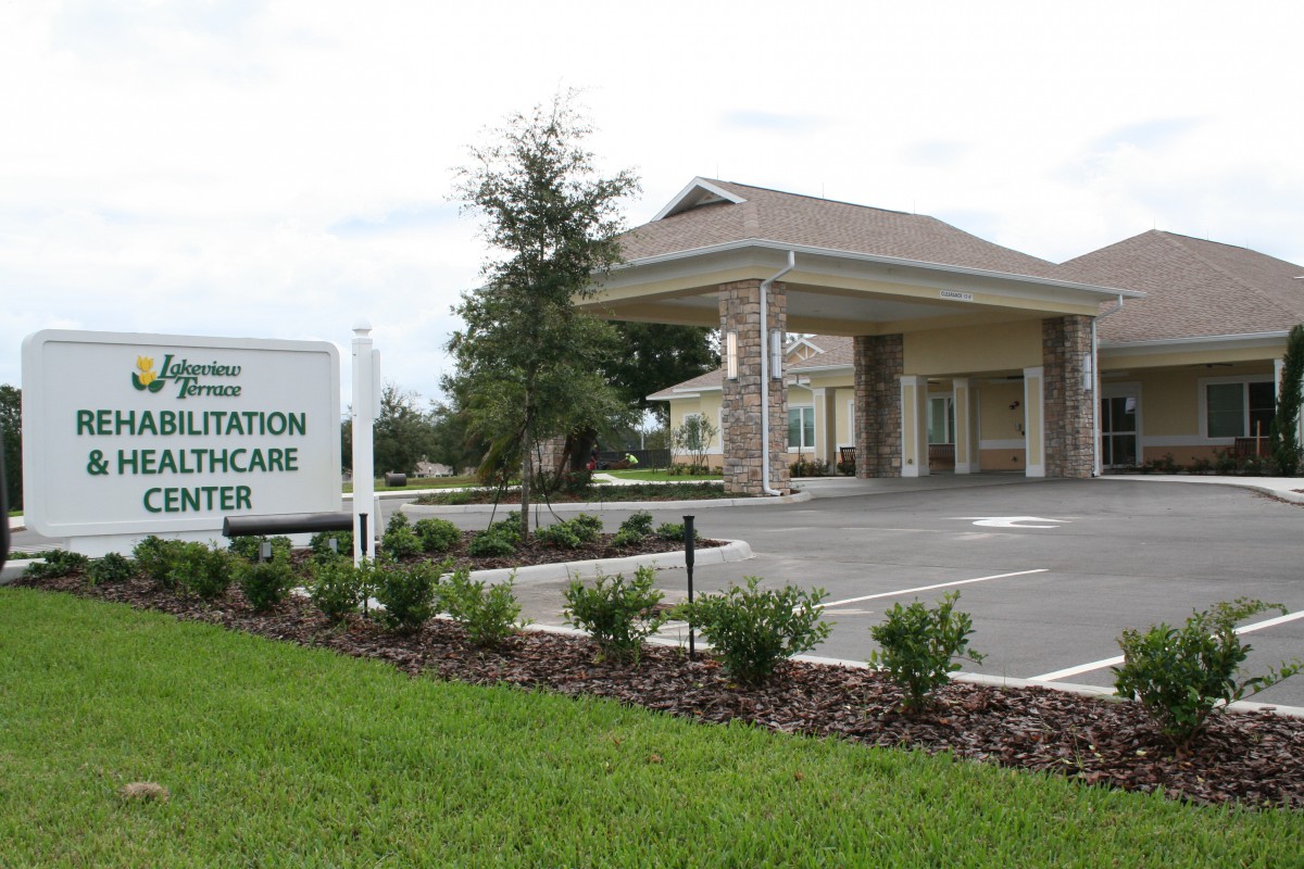 A healthcare center with a covered entrance and landscaped surroundings.