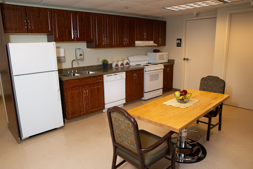 A modern kitchen featuring essential appliances and a cozy dining area.