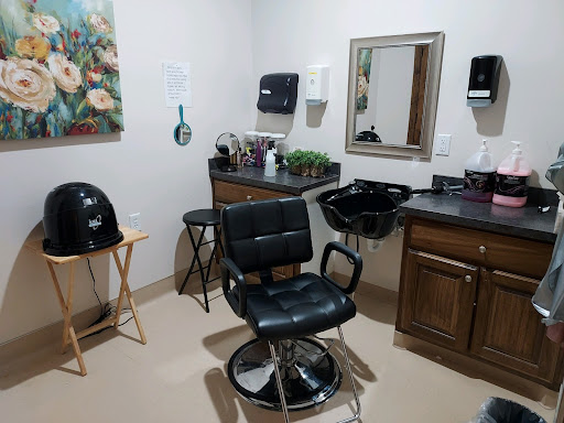 A cozy hair salon setup featuring a barber chair, mirror, and styling tools.