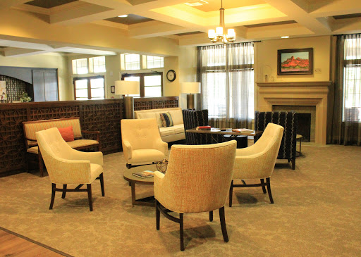 A cozy and inviting living room interior featuring comfortable seating and warm lighting.
