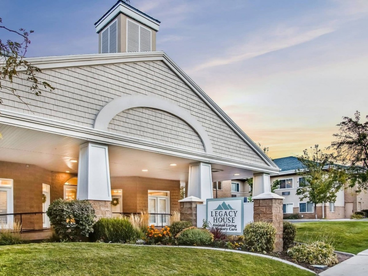 A modern residential building with an elegant entrance and well-maintained landscaping.