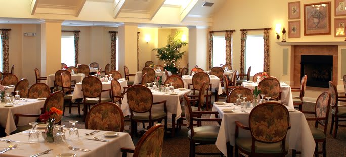 A beautifully arranged dining room with elegantly set tables and chairs.