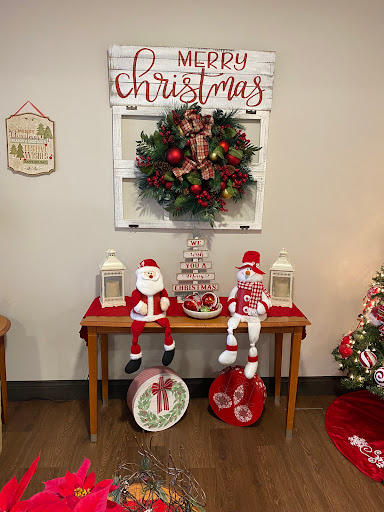 A cozy holiday display featuring a festive wreath, Santa decorations, and cheerful ornaments.