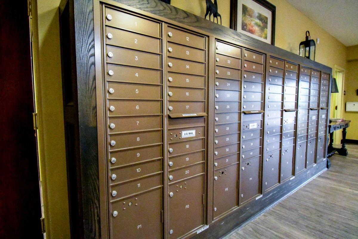 A wall of metal mailboxes in an interior setting.