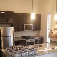 A modern kitchen with stainless steel appliances and a sleek countertop.