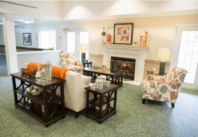 A cozy and modern living room featuring a fireplace, elegant furniture, and tasteful decor.