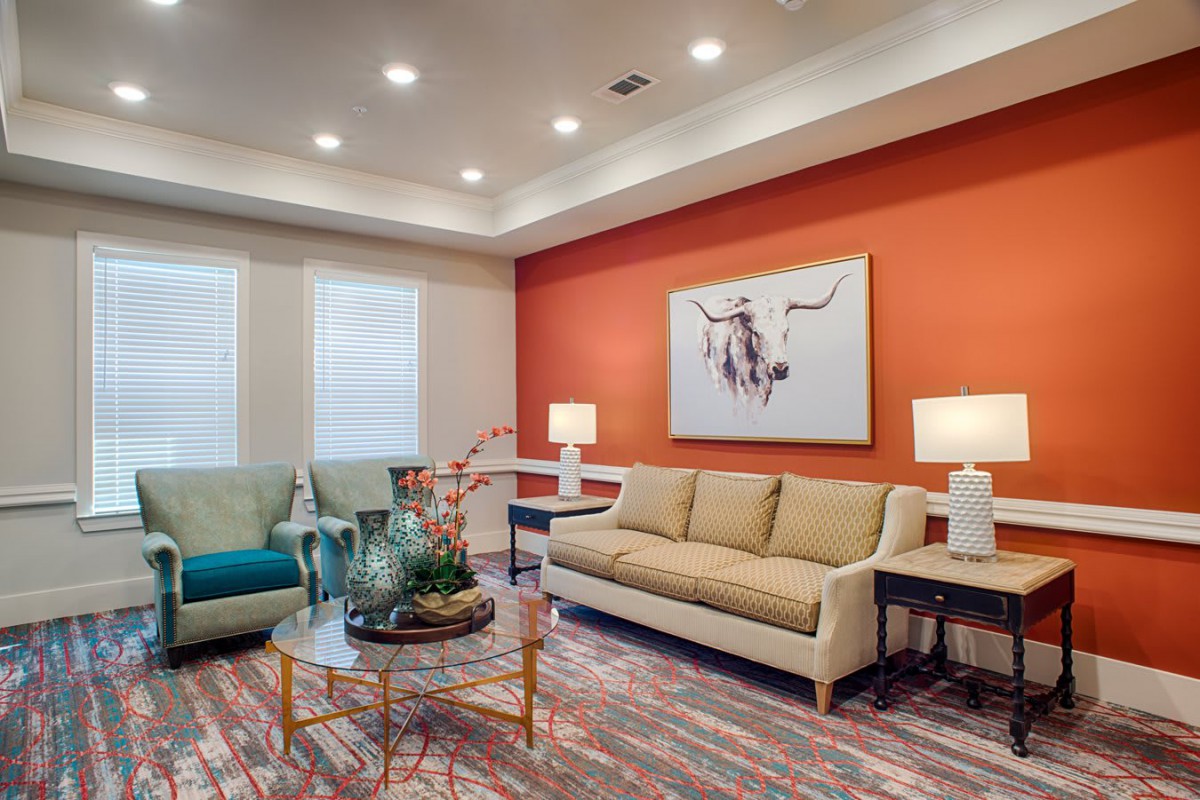 A modern living room with colorful accents and contemporary furniture.