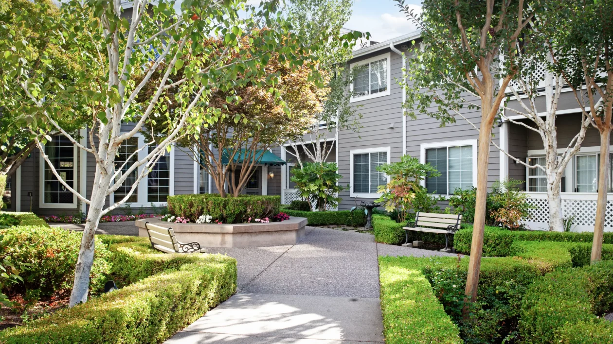 A charming residential area with a well-maintained garden and pathway.