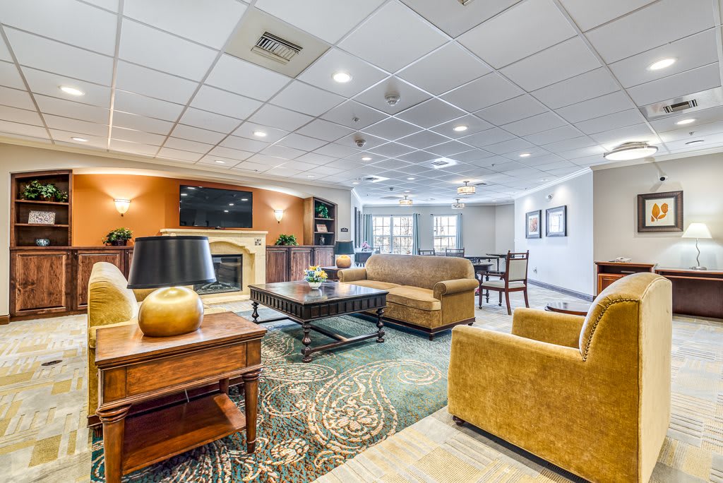 A spacious and well-lit living room with comfortable seating and a cozy atmosphere.