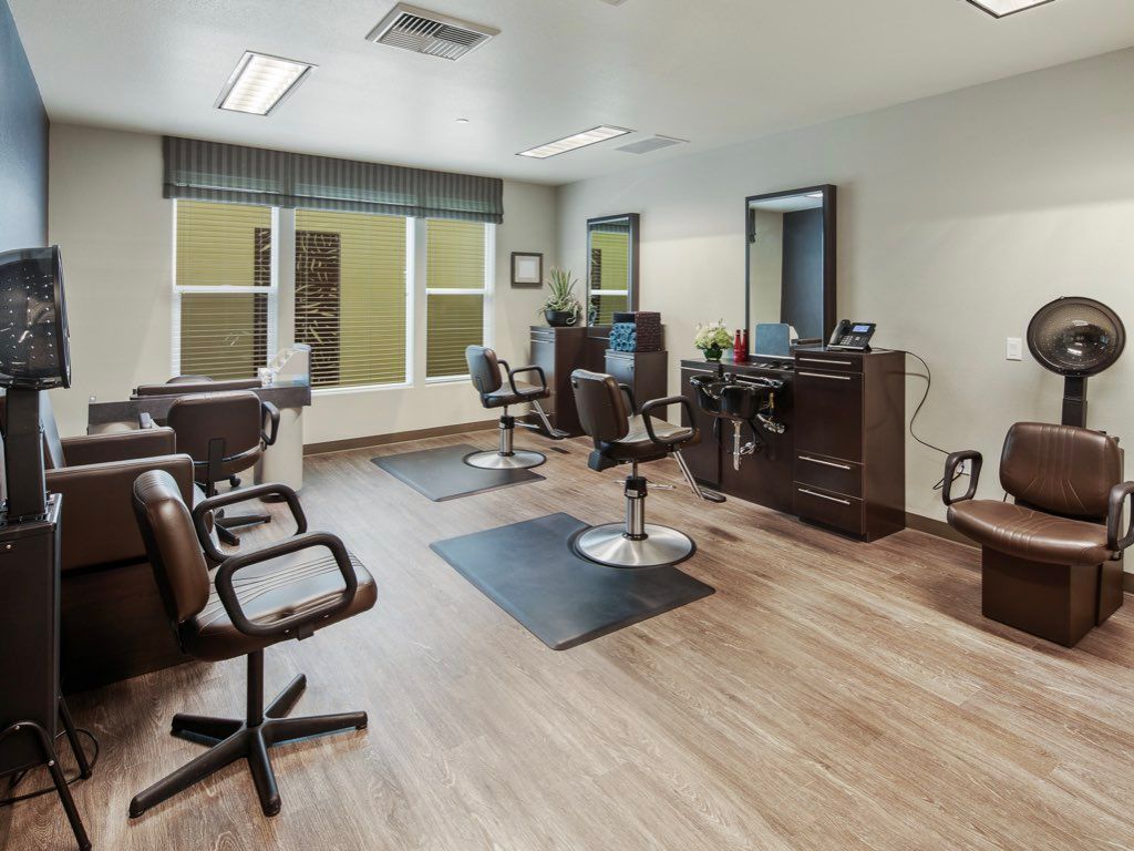 A modern hair salon with chairs and mirrors.