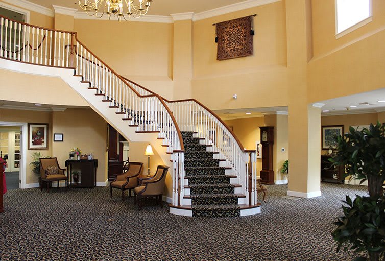 A grand staircase in an elegant hotel lobby with classic furnishings.
