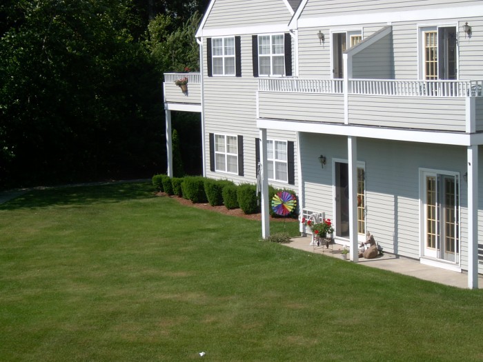 A residential house with a neatly maintained lawn and garden.