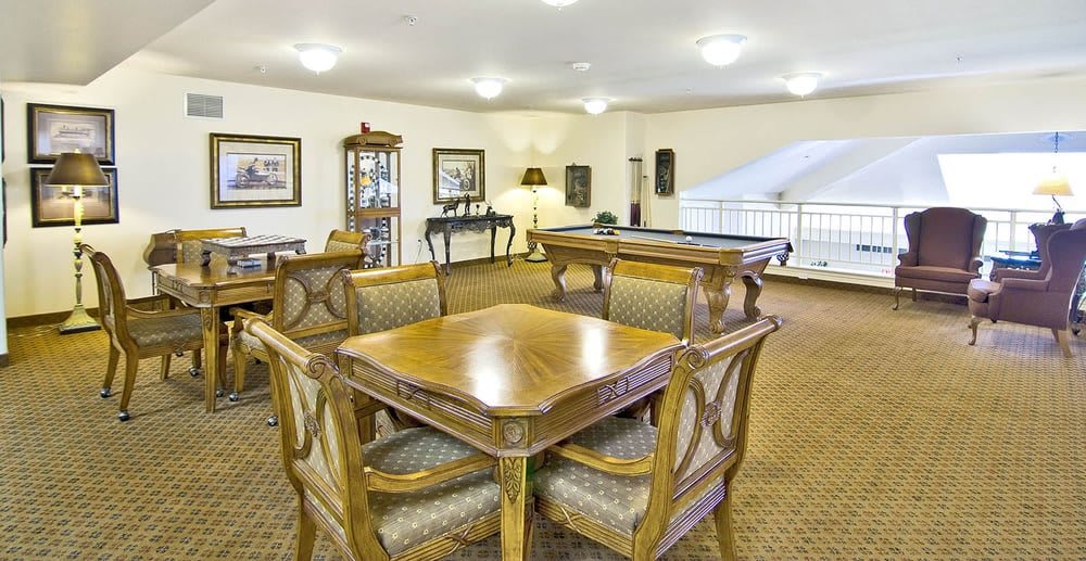 A classic and elegant lounge area featuring a wooden table and chairs.