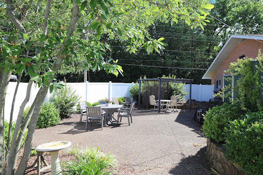 A serene outdoor patio area surrounded by greenery, perfect for relaxation.