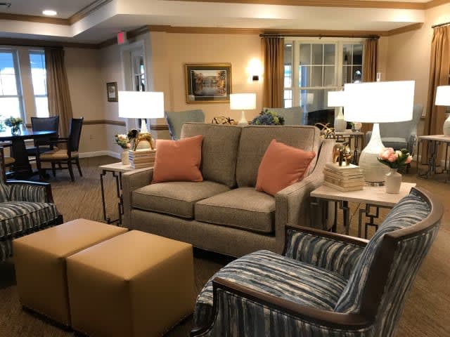 A cozy living room featuring a comfortable sofa, armchair, and soft lighting.