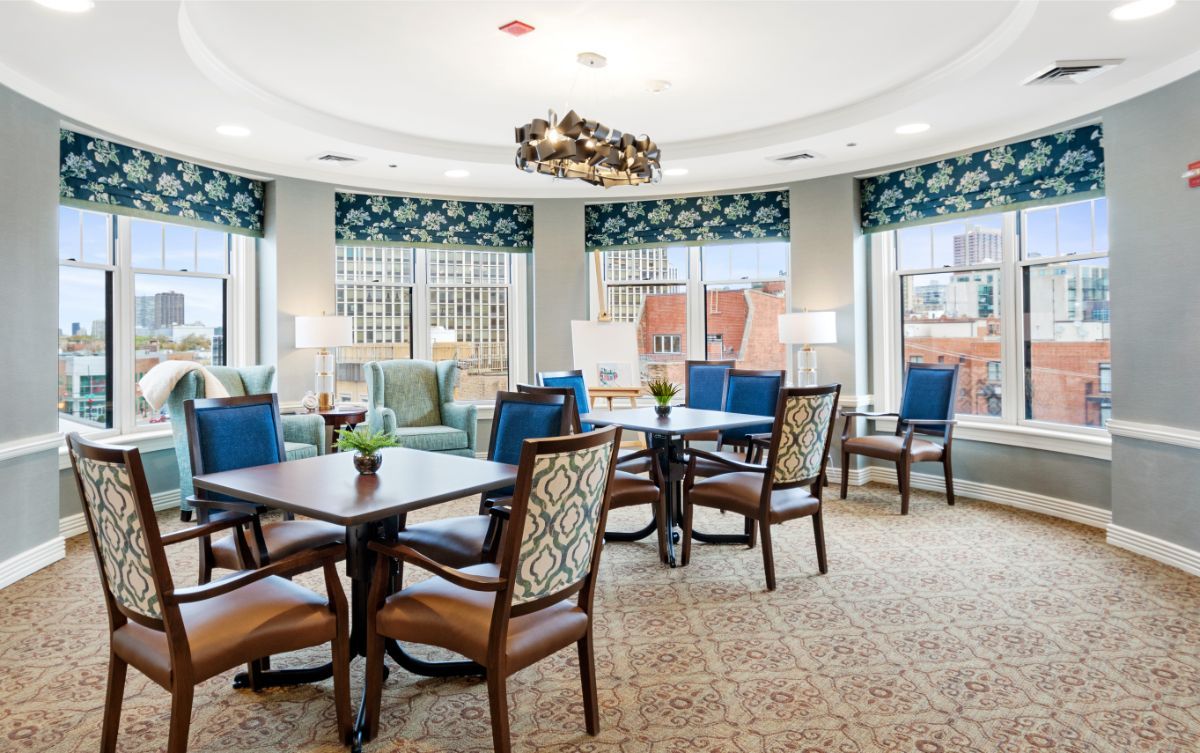 A well-lit lounge area with comfortable seating and large windows.