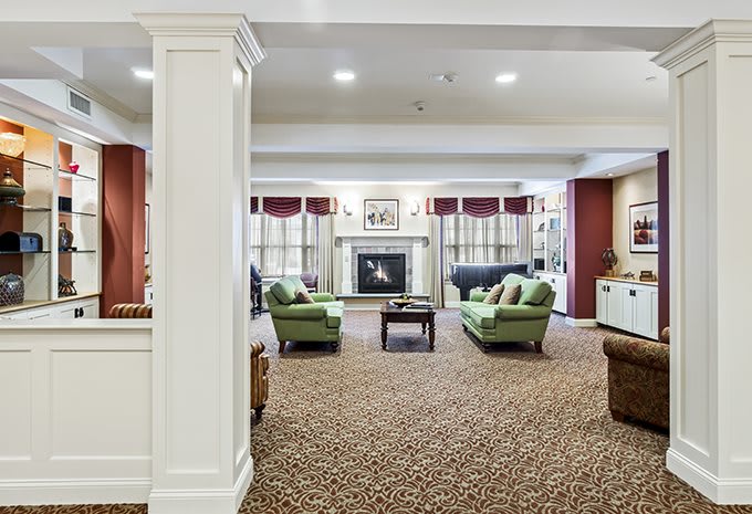 Spacious living room with comfortable seating and a central fireplace.
