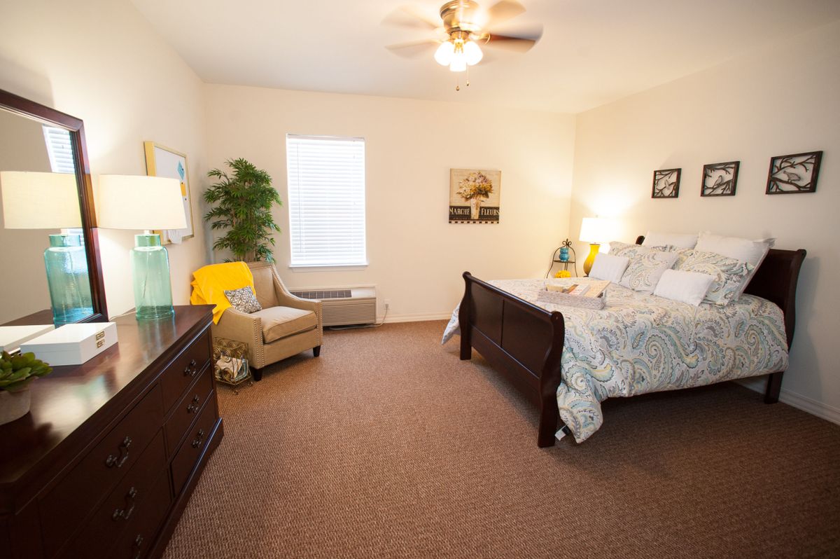 A cozy bedroom with a comfortable bed, stylish furniture, and warm lighting.