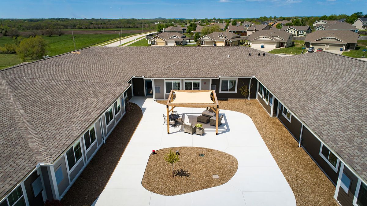 Aerial view of a suburban courtyard with a gazebo and patio seating.