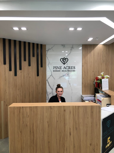 A reception area showcasing modern interior design with a wooden counter and elegant decor.