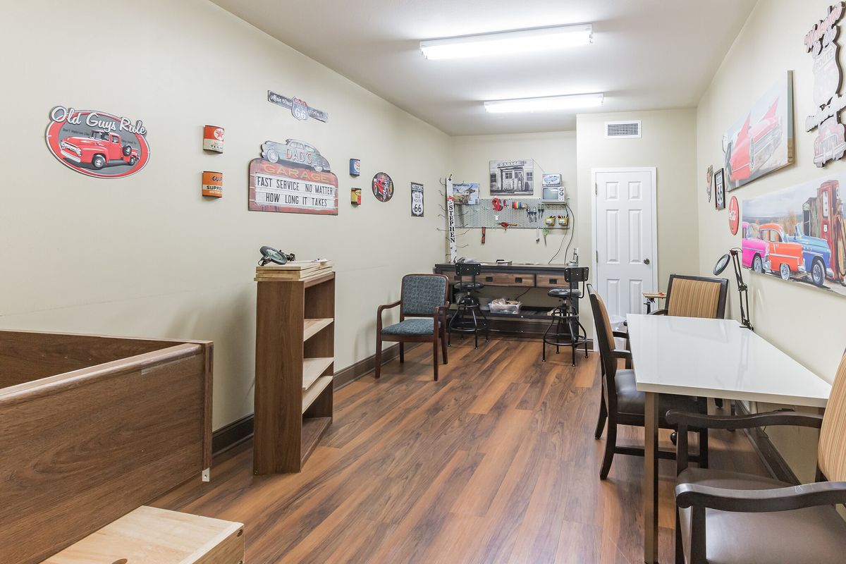 A cozy room with seating arrangements and decorative artwork on the walls.