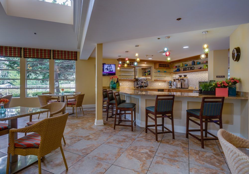 A cozy bar area with high chairs and ambient lighting.